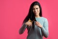 Angry young woman is going to cut hair. Royalty Free Stock Photo