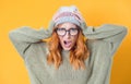 Angry young woman with hands on head and tearing hair out while looking to camera, isolated on white background Royalty Free Stock Photo