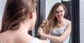 Angry young woman pulling out her long dry tangled hair Royalty Free Stock Photo