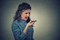 Angry young woman screaming on mobile phone Royalty Free Stock Photo