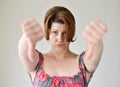 Angry young woman showing thumb down Royalty Free Stock Photo