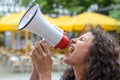 Angry young woman using a loud hailer Royalty Free Stock Photo