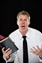 Anguished young man holding bibles Royalty Free Stock Photo