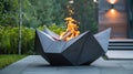 The angular and geometric sculptures contrast with the organic shapes of the flames in the fire pit creating a