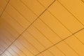 Angular view of warm yellow color tiled wall with perspective