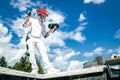 Animal animator. Animator in a dog costume dancing against the blue sky Royalty Free Stock Photo