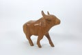 Carved wooden bull and white backdrop