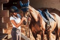 Animal is in blue clothes. Horsewoman in uniform and black protective helmet with her horse Royalty Free Stock Photo