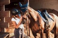 Animal is in blue clothes. Horsewoman in uniform and black protective helmet with her horse Royalty Free Stock Photo