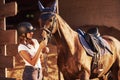 Animal is in blue clothes. Horsewoman in uniform and black protective helmet with her horse Royalty Free Stock Photo