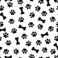 Animal paw footprint seamless pattern. Dog paw print and bone on white background. Royalty Free Stock Photo