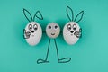 Animated character from a pebble with a happy face holds animated happy eggs on blue paper background. Heppy easter
