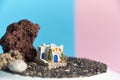 Animated model of a Greek house on a rock on a neon and pink background.