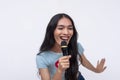 An animated and upbeat trans woman belting out a high tune, singing to lively pop song while holding a microphone. Karaoke time