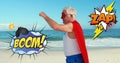 Boom and Zap text on speech bubble against senior in superhero costume on the beach