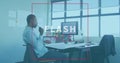 Animation of flash sale text banner over thoughtful frican american man working on a plan at office