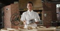 Animation of of happy asian female baker sieving flour on board