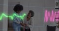 Animation of heart rate monitor over diverse female healthworker helping senior woman to walk