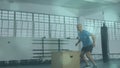 Animation of lens flares over caucasian bald man practicing plyometric exercise on box in gym