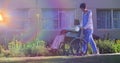 Animation of light moving over nurse wheeling senior man in wheelchair