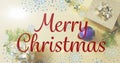 Animation of merry christmas text and snowflakes floating ove christmas decorations and gifts