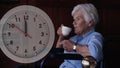 Animation of moving clock over disabled cuacasian woman sitting in wheelchair