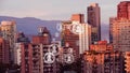 Animation of multiplying people icons moving over modern cityscape and mountain range