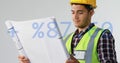 Animation of plus, minus, percentile symbols, caucasian engineer wearing helmet looking at blueprint