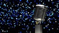 Animation of rerto microphone over bokeh on dark background