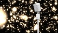 Animation of rerto microphoneover shining bokeh on black background