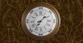 Animation of retro clock ticking showing midnight with gold patter on brown background