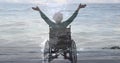 Animation of sea landscape over disabled cuacasian woman sitting in wheelchair