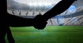 Animation of silhouettes of players shaking hands over sports stadium