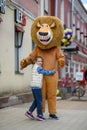 Animator in the costume of Alex the lion from the cartoon Madagascar in the city.