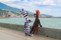 Animators dressed as horses and zebras on the waterfront of the seaside tourist city