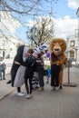 Animators in a lion, zebra and penguin costume from the cartoon Madagascar are photographed with girls on the street