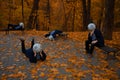 Anime cosplay one person in four poses with self hand made mask of big circle weirs head, atmospheric autumn park October