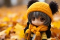 an anime doll wearing a yellow hat and black scarf Royalty Free Stock Photo