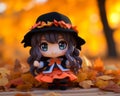 an anime figurine wearing a witch hat and an orange dress