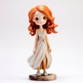 Anime-inspired Ceramic Figurine Of A Red-haired Girl In A White Dress Royalty Free Stock Photo