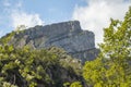 Anisclo Canyon peak seen through leaves, with swirling clouds above. Royalty Free Stock Photo