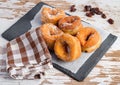 Anise donuts on a piece of paper and a blackboard with some raisins