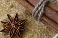 Anise star and cinnamon sticks on brown cane sugar background, c Royalty Free Stock Photo