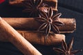 Anise star spices and cinnamon sticks on dark rystic wooden background