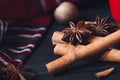 Anise star spices and cinnamon sticks on dark rystic wooden background