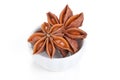 Anise star in a white bowl on white background Royalty Free Stock Photo