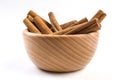 Anise stars and cinnamon sticks in wooden bowl isolated on white background Royalty Free Stock Photo