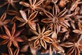 Anise stars closeup in wooden bowl on dark background