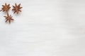 Anise stars on a light background. Fragrant spices star anise. Copy space for text.