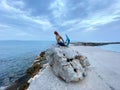 Mermaid sculpture on a rock at Analipsi beach, Crete, Greece